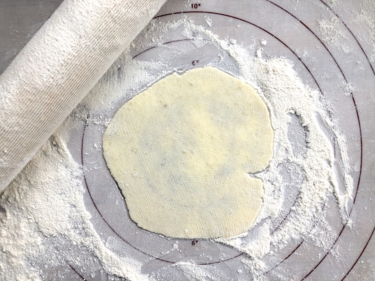Lefse rolled into a 6" circle on a silicone rolling mat.