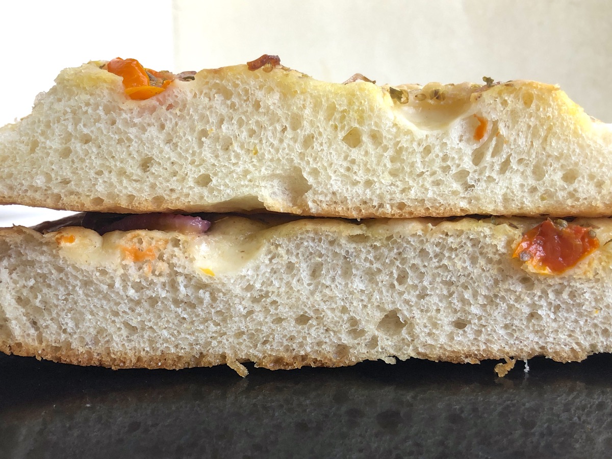 Cross section of focaccia made with all-purpose flour and focaccia made with a combination of all-purpose and rye flours, showing their similar rise.