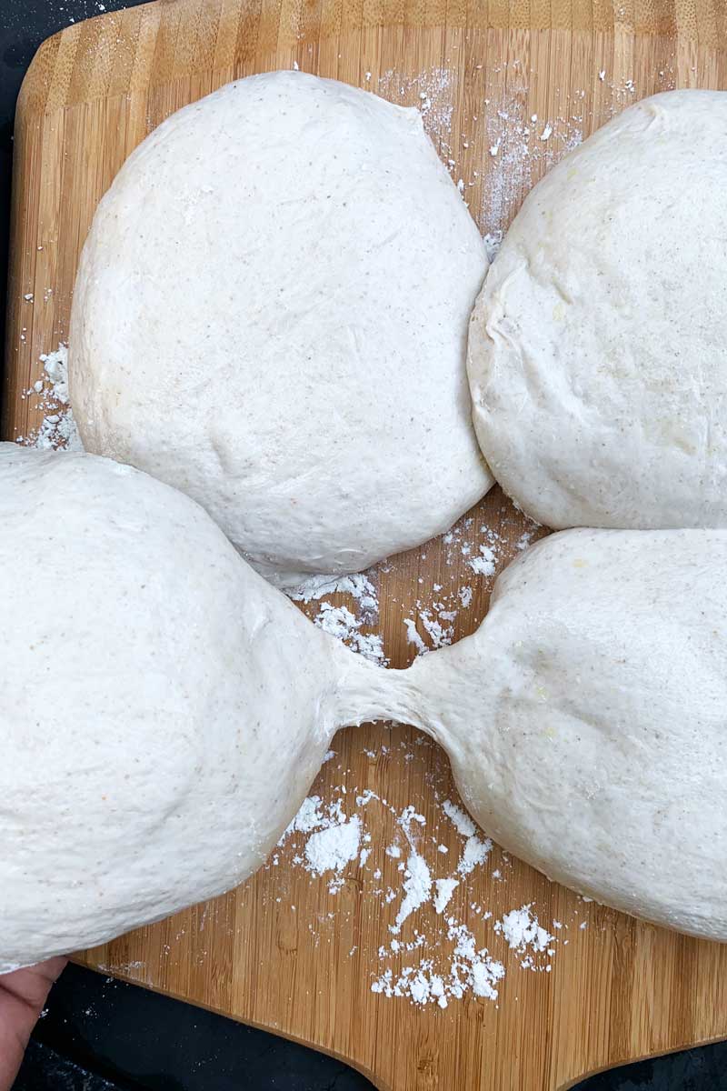 Four balls of dough on a baking surface