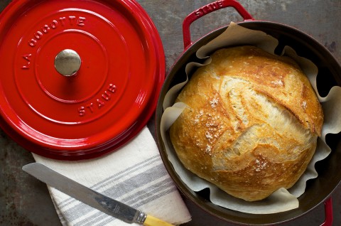 An overhead photo of a loaf of crusty bread that was baked in a round Dutch oven.  - select to zoom