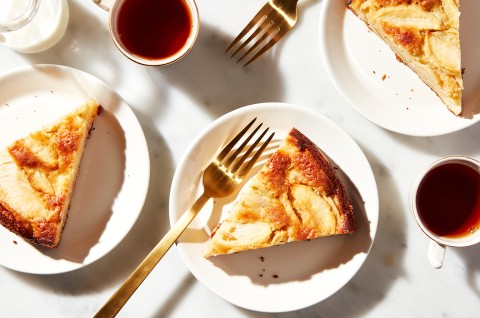 Mostly Apples Apple Cake cut into slices and plated with forks and tea, ready to be eaten - select to zoom