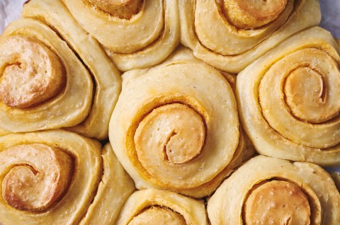 A close up overhead photo of Buttery Sourdough Buns with a swirl of paprika in them. - select to zoom
