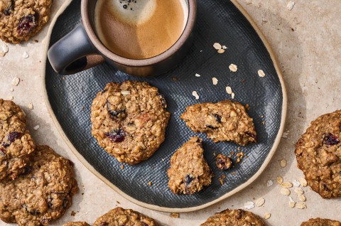 Oatmeal and Flax Cranberry Cookies on a plate with a cup of coffee - select to zoom