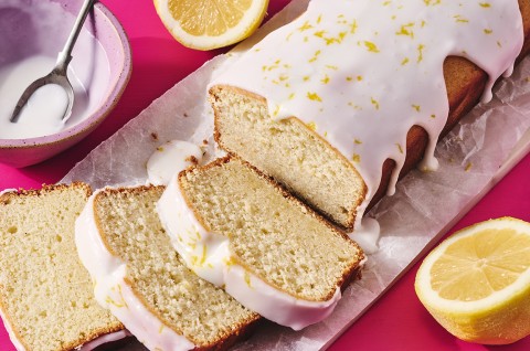 Glazed Sourdough Lemon Cake sliced up on parchment paper - select to zoom