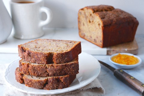 Banana bread stacked on a plate with the rest in the background - select to zoom