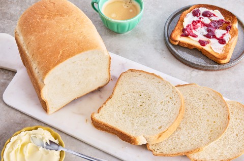 Bread Machine Sourdough Bread sliced up on a cutting board - select to zoom