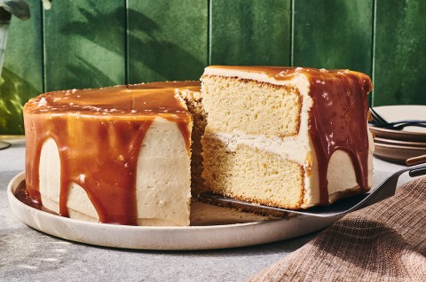 Caramel Layer Cake with Brown Butter Frosting with a slice being taken out - select to zoom