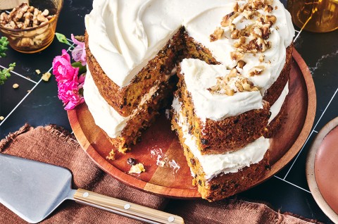 Close up of Gluten-Free Carrot Cake with Cream Cheese Frosting with a slice cut out - select to zoom