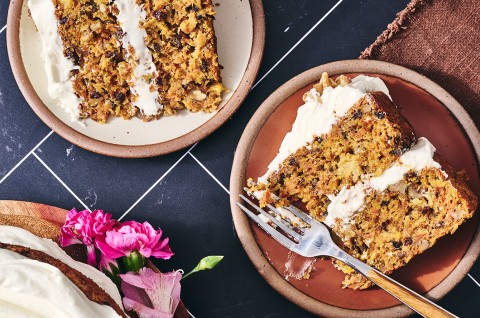 Two slices of Gluten-Free Carrot Cake with Cream Cheese Frosting on plates - select to zoom