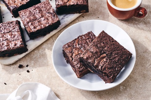 Gluten-Free Brownies on a plate with some coffee - select to zoom
