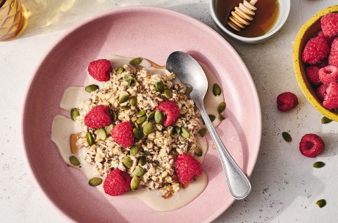 Simple Overnight Oats on a plate with raspberries and honey - select to zoom