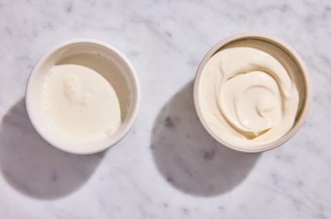 A bowl of leftover heavy cream next to a bowl of creme fraiche