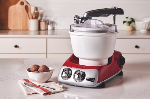 Ankarsrum mixer with ice cream attachment sitting on counter.