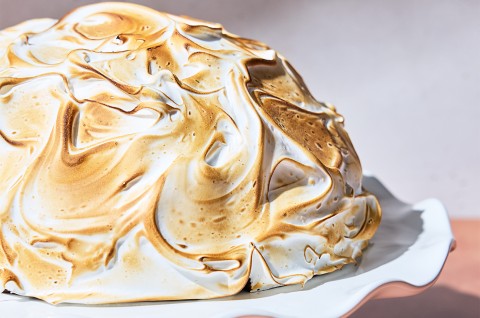 Baked Alaska on a serving tray un-cut - select to zoom