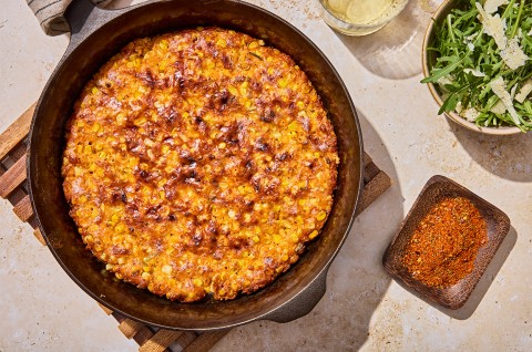 A complete Giant Cheesy Corn Fritter in skillet - select to zoom