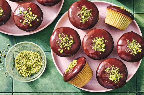 Pistachio-Cardamom Cupcakes with Dark Chocolate Ganache on a plate - select to zoom