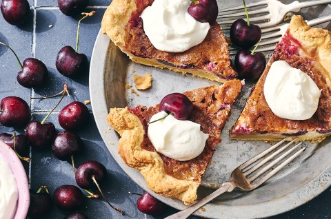 3 slices of Cherry-Vanilla Cream Pie in a pie dish topped with whipped cream - select to zoom