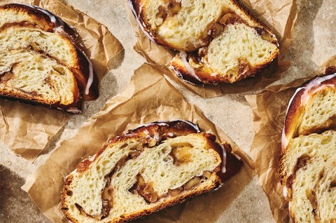 Slices of Cinnamon Apple Twist Bread on parchment paper - select to zoom