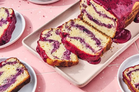 A Lemon Blueberry Loaf Cake with slices cut from it - select to zoom