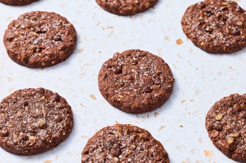 Baked Chocolate Lactation Cookies arranged evenly on a baking sheet. - select to zoom