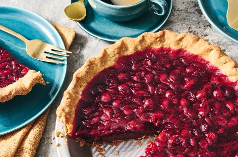 Cranberry-Fudge Pie in a pie tin with a slice removed. - select to zoom