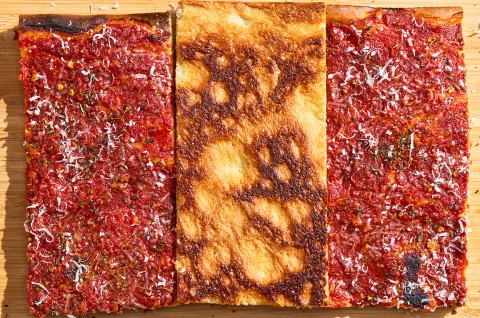 Top down photograph of Rhode Island Pizza Strip showing the middle slice bottom up with golden brown baked tones. - select to zoom