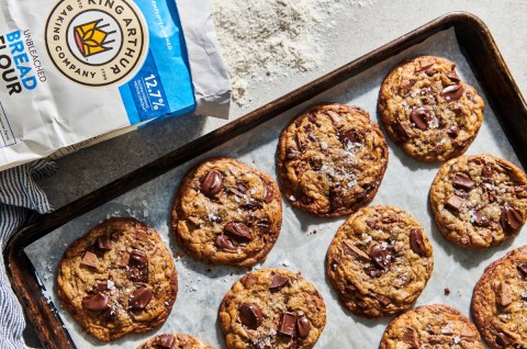 Tray of cookies next to a bag of bread flour