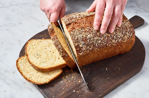 Slicing a loaf of Multigrain Protein Bread. - select to zoom