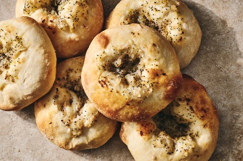 Classic Bialys stacked together with herbs and golden crust on each. - select to zoom