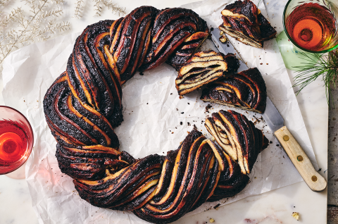 A Chocolate Babka Wreath on counter with slices showing the layers of the bake. - select to zoom