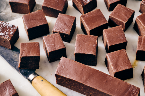 Easy Microwave Fudge cut into neat squares and shown on a light colored marble counter. - select to zoom