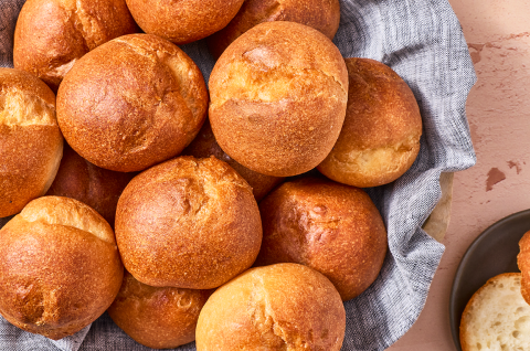 Freshly baked gluten-free rolls in a basket seen from above. - select to zoom