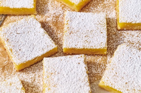 Gluten-Free Lemon Squares with an Almond Flour Crust on parchment. - select to zoom