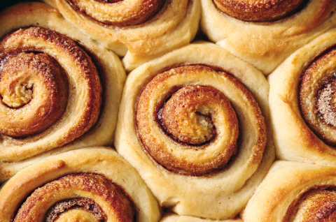 Sticky Buns fresh out of the oven before topping showing spiral rolls and cinnamon filling. - select to zoom