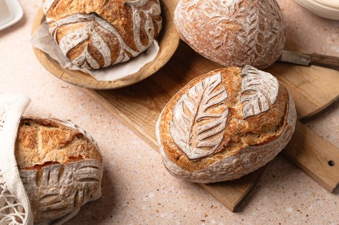 Loaves of sourdough with intricate scoring designs
