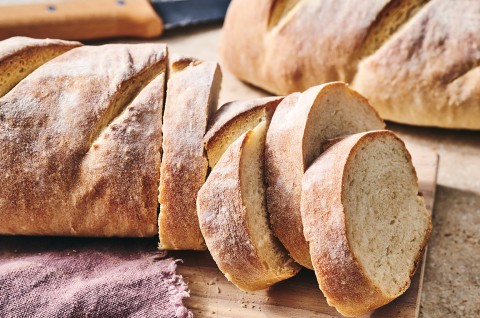 The easiest loaf of bread you'll ever bake shown sliced on a counter. - select to zoom