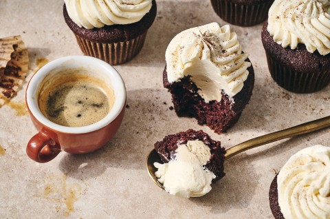 Irish Cream Cupcakes seen from above with a spoonfull of cupcake and frosting in the photo. - select to zoom