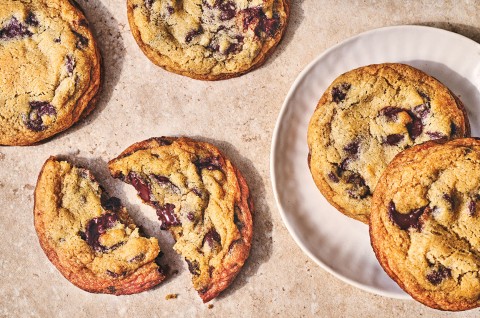 Classic Chocolate Chip Cookies spread out on a countertop. - select to zoom