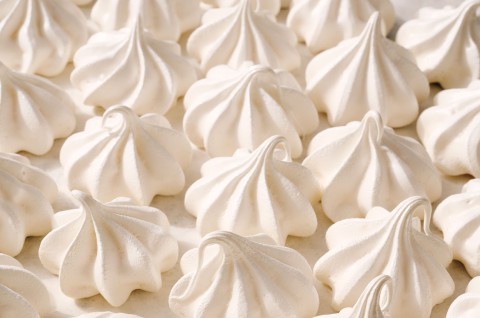 Detailed shot of Meringue Kisses tightly organized on a counter. - select to zoom