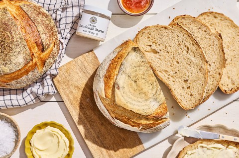 Naturally Leavened Sourdough Bread sliced on a cutting board seen from above. - select to zoom