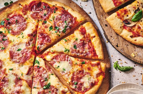 Two pizzas seen from above on wooden pizza peels - select to zoom