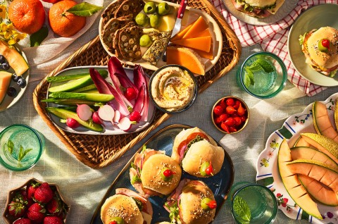 Hot Party Sandwiches on an elaborate table with other vegetables, dips, and lunch items - select to zoom