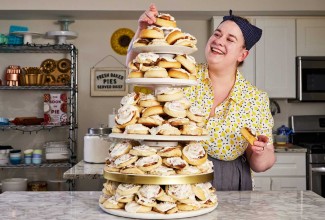 Erin placing a roll on her cinnamon roll tower