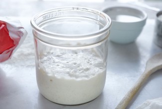 Sourdough culture in a clear glass jar.