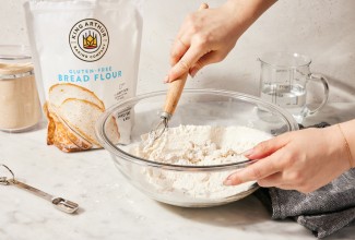 Baker mixing bread dough with gluten-free bread flour