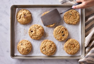 Cookie being smashed with a metal spatula