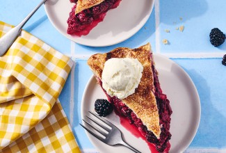 A slice of Gingery Blackberry Pie on a plate