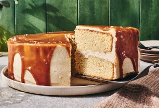 Caramel Layer Cake with Brown Butter Frosting with a slice being taken out