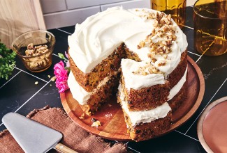 Gluten-Free Carrot Cake with Cream Cheese Frosting with a slice cut out