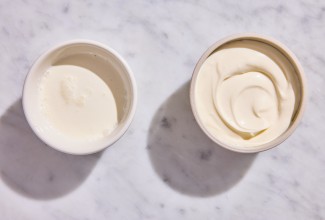 A bowl of leftover heavy cream next to a bowl of creme fraiche